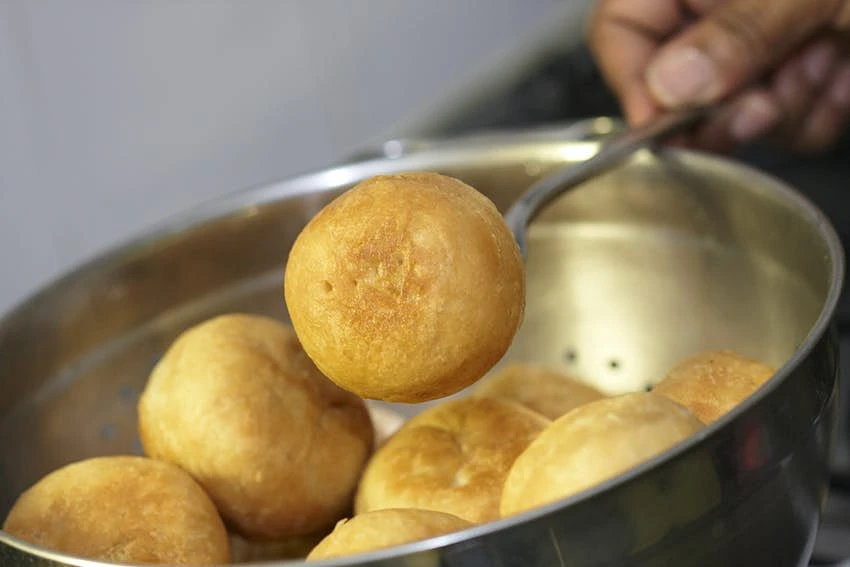 West Indian Johnny Cakes being prepared and baking West Indian Johnny Cakes being prepared and baking