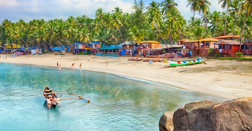 Beautiful beach in the province of Goa in India with fishing boats and stones in the sea
