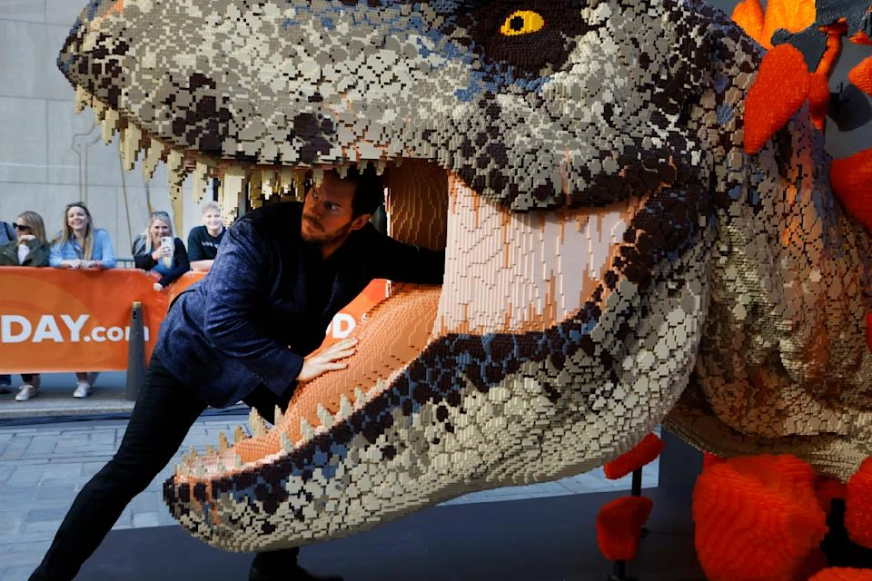 Pratt clowns around with a Lego T. rex on the Today show. (Photo by Jason DeCrow/Invision for NBCUniversal and LEGO/AP Images)