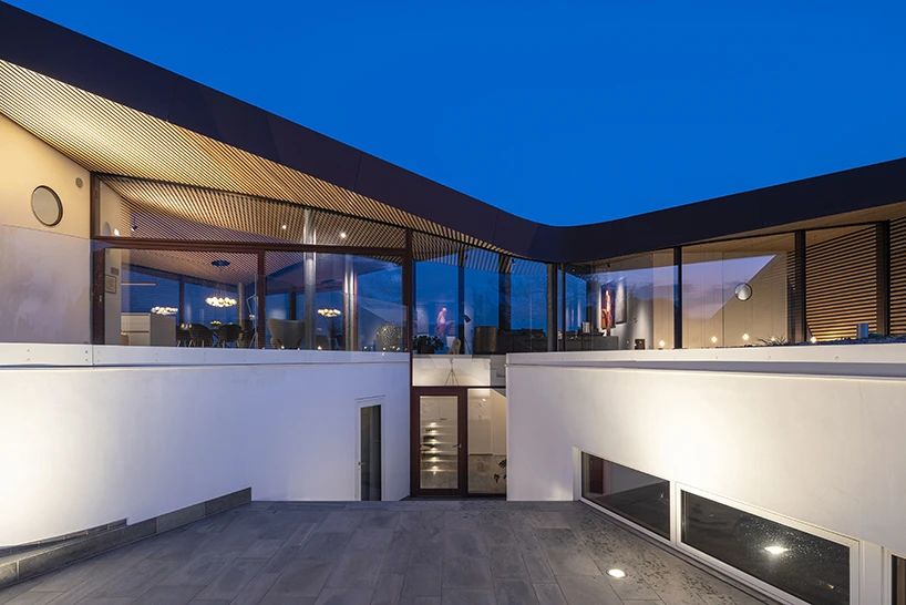 CEBRA forms a Danish seaside villa as an angular living sculpture with a wavy roof