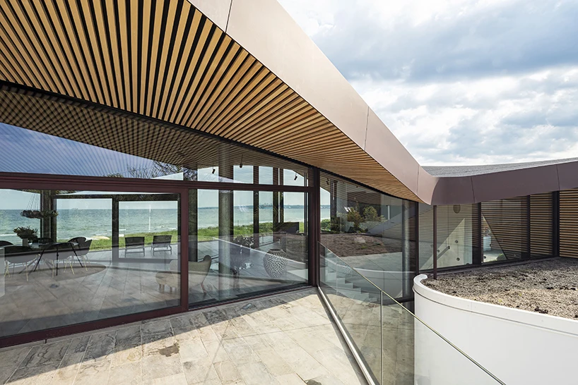 CEBRA forms a Danish seaside villa as an angular living sculpture with a wavy roof